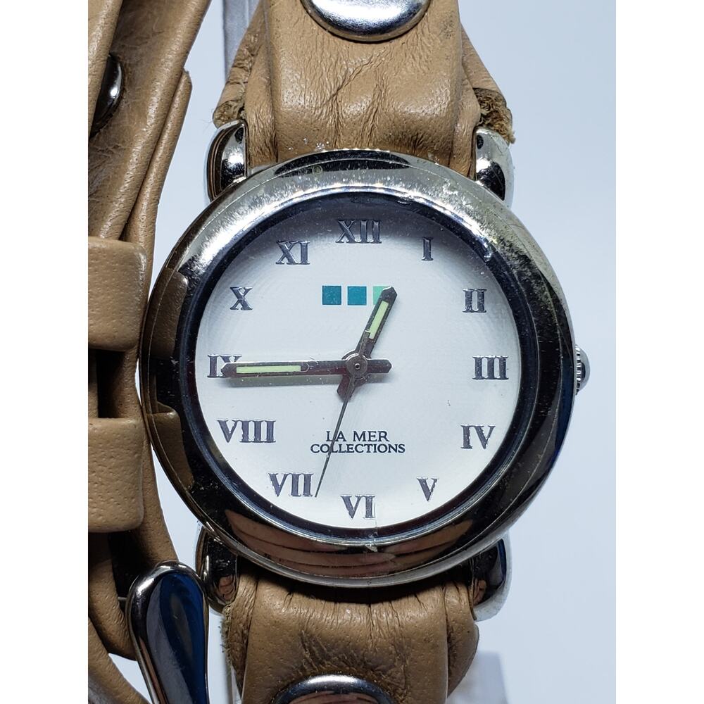 La Mer Collections women's watch. Wrap around cream band with silver accents
